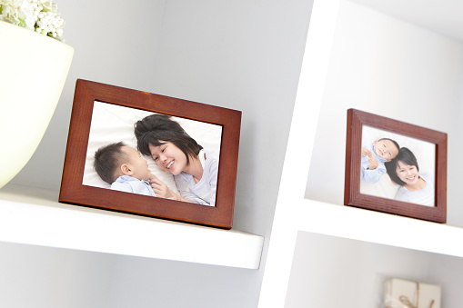 Happy Family photo on white bookshelf at home