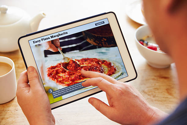 istock Person At Breakfast Looking At Recipe App On Digital Tablet 486507496