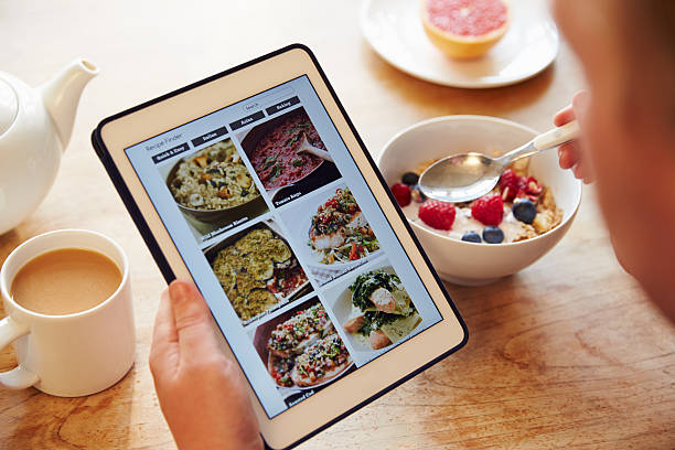 istock Person At Breakfast Looking At Recipe App On Digital Tablet 486507816