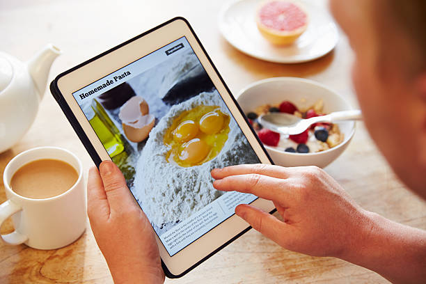 istock Person At Breakfast Looking At Recipe App On Digital Tablet 486507826