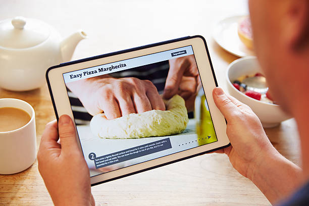istock Person At Breakfast Looking At Recipe App On Digital Tablet 486507872