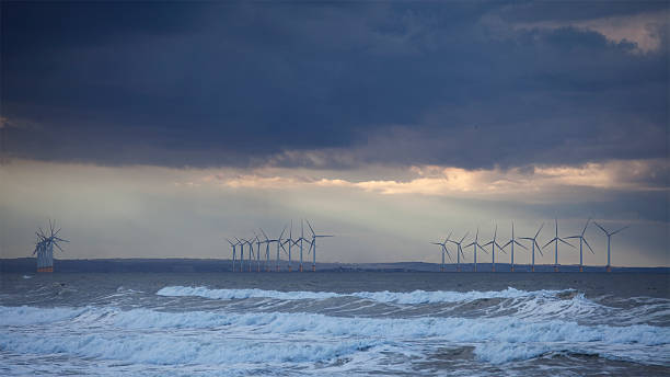 Offshore Wind Turbines under Stormy Skies The offshore wind farm at Redcar, England, under a stormy evening sky teesside northeast england stock pictures, royalty-free photos & images