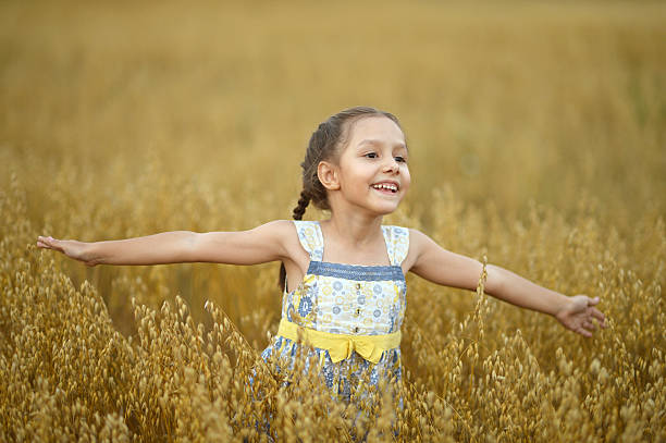 istock Little  girl in wheat field 486515534