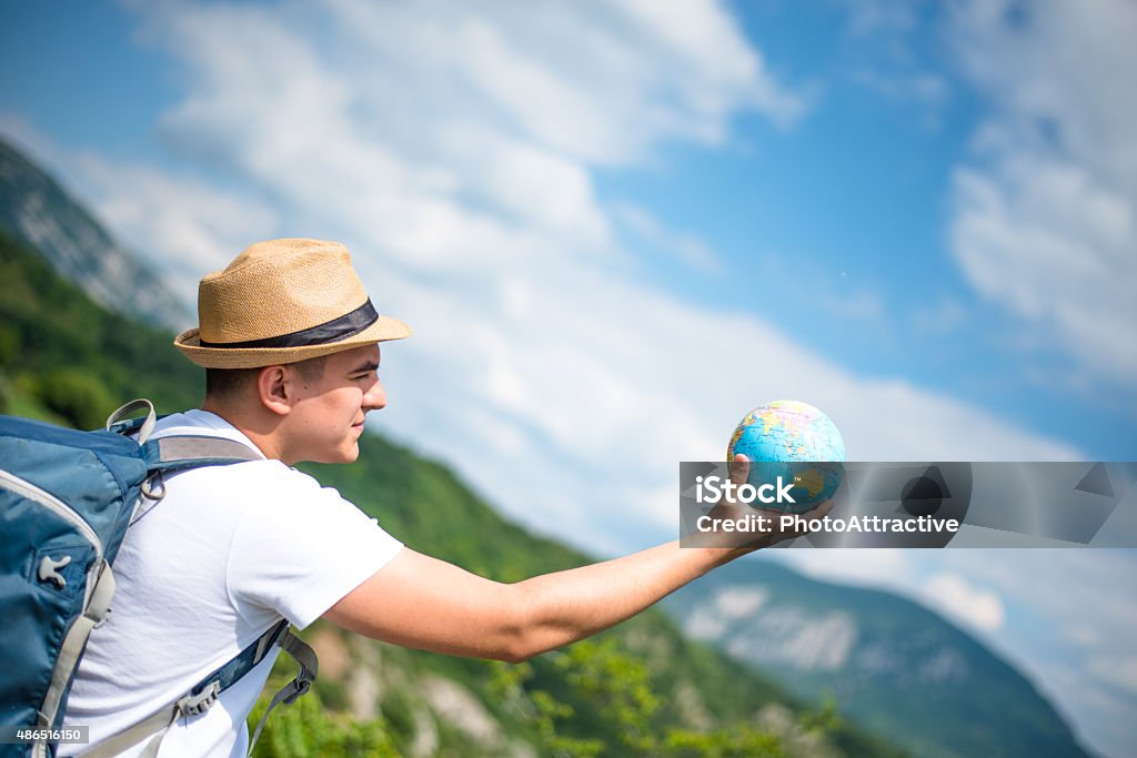 Man with globe on mountain 2015 Stock Photo