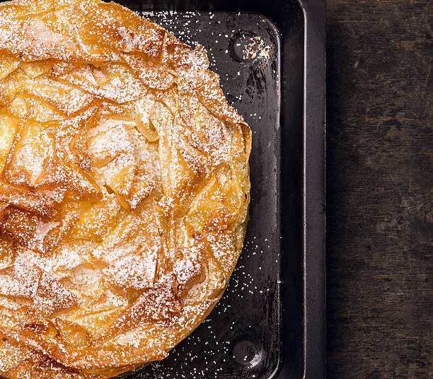 istock Filo pastry pie on old  baking tray, top view 486516442