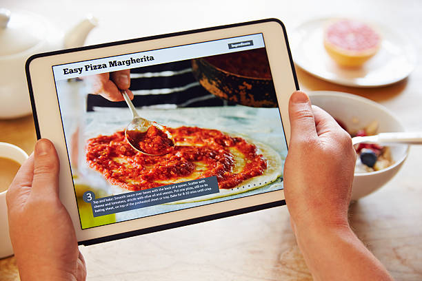 istock Person At Breakfast Looking At Recipe App On Digital Tablet 486522044
