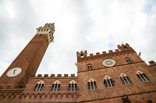 Famous Tower Torre del Mangia at Piazza del Campo in Siena, Tuscany, Italy. Siena is an UNESCO World heritage site. Photo made with high quality photo equipment in public area. Free copy space for your text. Spring 2014.