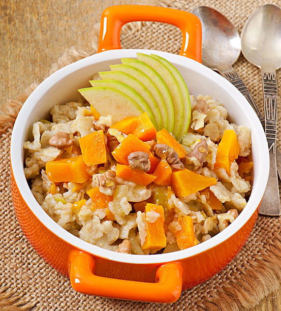 istock Oatmeal with pumpkin, apples, nuts and honey 486522799