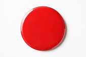 Isolated shot of blank red badge on white background