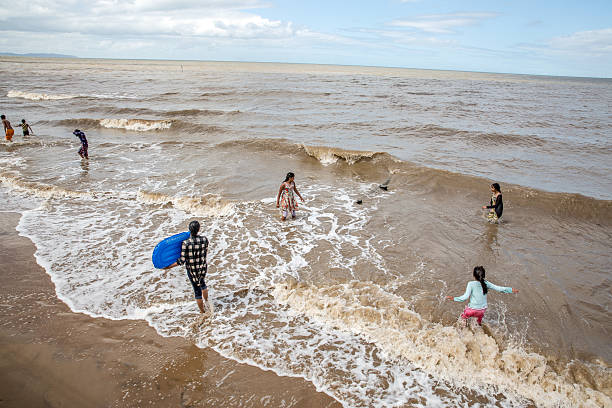 Rhyl, UK - August 3, 2015: Indian family bathing in the sea at Rhyl in North Wales coastline