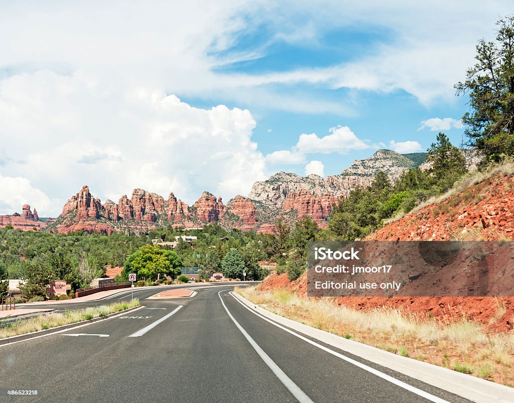 Beautiful Mountains and Clouds in Sedona Arizona Sedona, Arizona, USA - July 2, 2015: This view of entering this very popular destination of Sedona Arizona shows a resort on the edge of the community as well as homes spread out on the hill side and all of this is  surrounded by fantastic mountains under a beautiful cloudy sky any way you enter Sedona you are entranced with the beautiful mountain formations this entrance from the South on this beautiful day in July makes this travel decision, perfect. Sedona Stock Photo