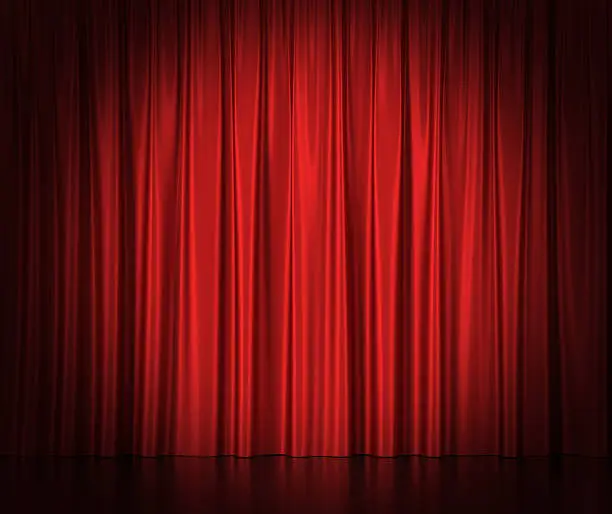 Photo of Red silk curtains for theater and cinema spotlit light in