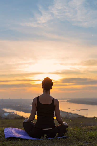 istock Young girl meditating and looking at sunset 486525791