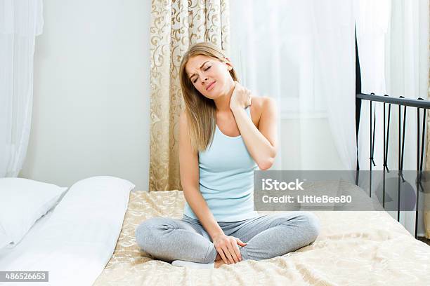 Neck Pain Stock Photo - Download Image Now - Bed - Furniture, Neckache, 20-24 Years