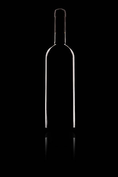 istock bottle of red wine on black background 486527628