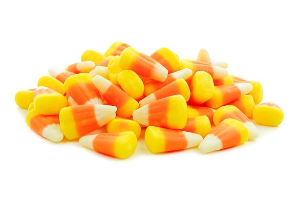 Pile of Halloween candy corn over white