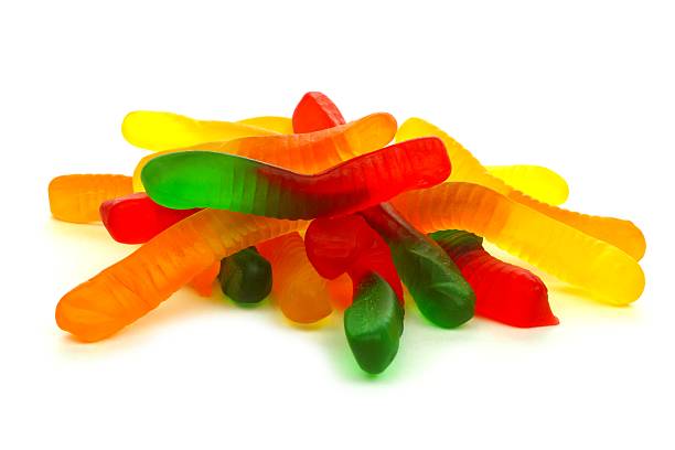 Pile of candy gummy worms over white