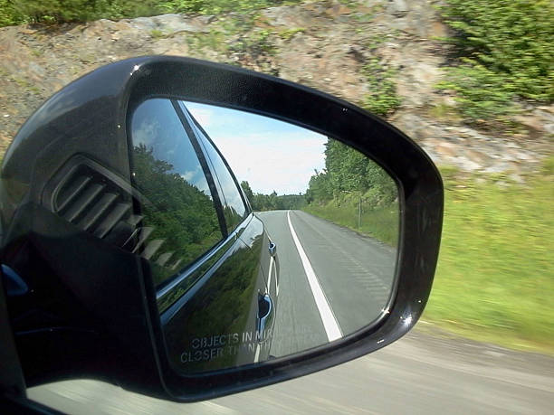 istock Side View Car Mirror Reflecting The Road Behind 486528804