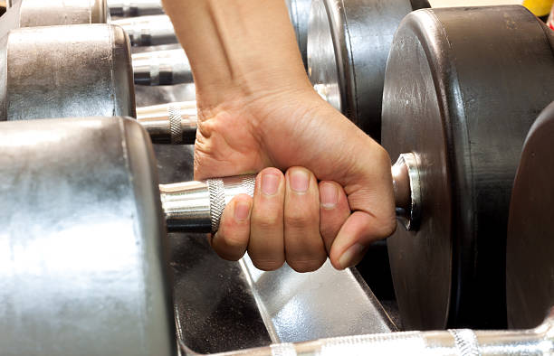 istock Hand someone holding dumbbell in gym. 486528964