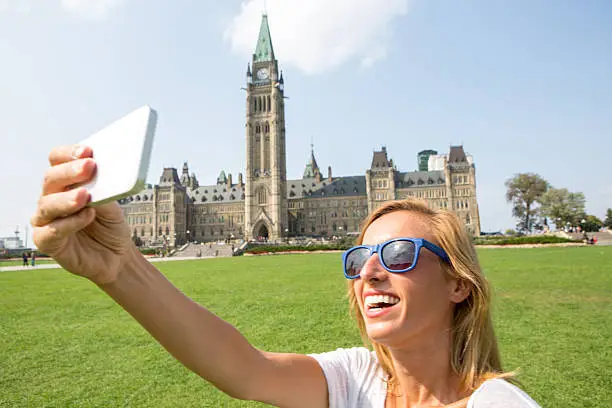 Photo of Young cheerful woman in Ottawa-Canada taking a selfie portrait