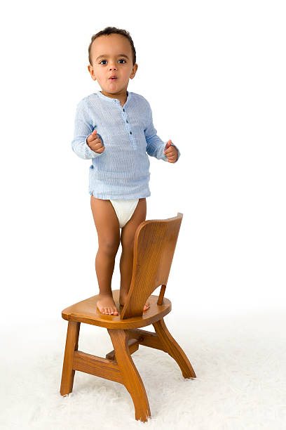istock Toddler standing on chair 486529608