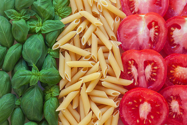 italian food with background italian food with background - pasta, tomato, basil italian food stock pictures, royalty-free photos & images