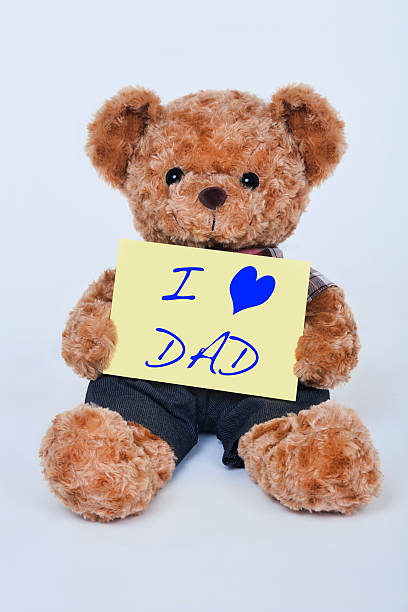 istock Teddy bear holding  yellow sign that says I love dad 486531448