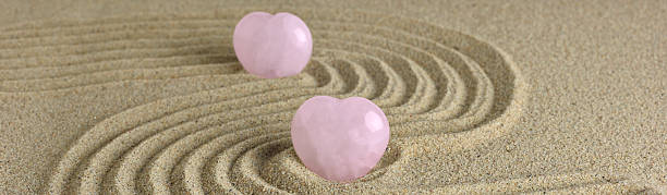 istock Rose Quartz heart in zen garden 486532824