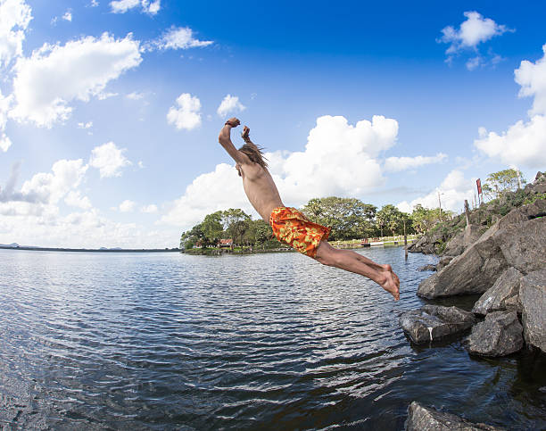 istock Teenage boy jumping in the river 486537844