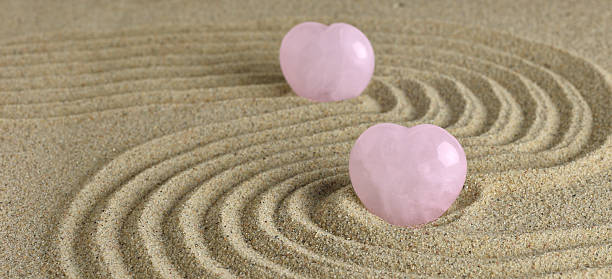 istock Rose Quartz heart in zen garden 486538392