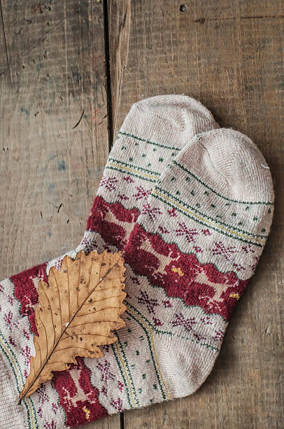 istock Knitted woolen socks and oak leaf 486539424
