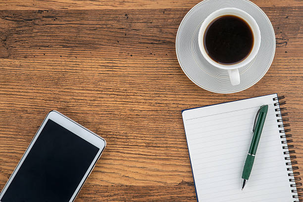 istock Tablet, notebook and pen with a cup of coffee 486539546