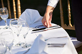 Waiter Setting The Table In Restaurant