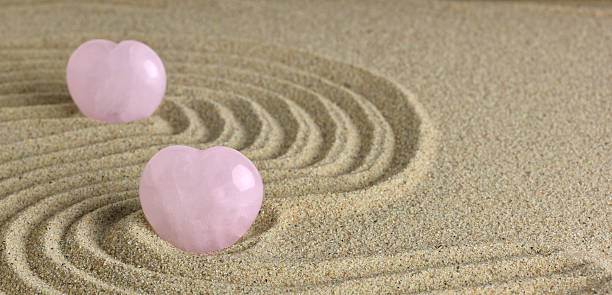 istock Rose Quartz heart in zen garden 486541900