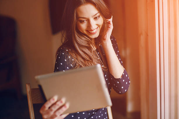 istock beautiful young girl enjoys phone and tablet 486543624