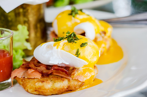 Eggs Benedict- toasted English muffins, ham, poached eggs, and delicious buttery hollandaise sauce