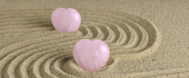 istock Rose Quartz heart in zen garden 486544604