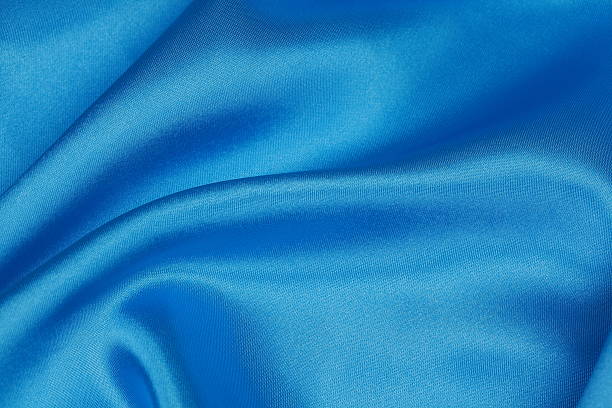 Blue Silk cloth of wavy abstract background Blue Silk cloth of abstract background or wavy folds or satiny silk texture satin velvet material or elegant wallpaper design curve. royal blue curtains stock pictures, royalty-free photos & images