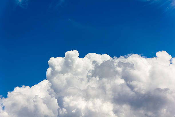 istock big puffy clouds in light cheerful blue sky 486546672