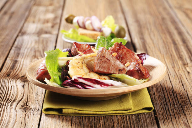 istock Pan fried pork and vegetable salad 486547108