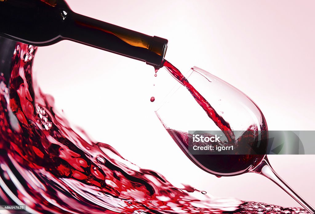 Red wine bottle and glass with red wine Pouring Stock Photo