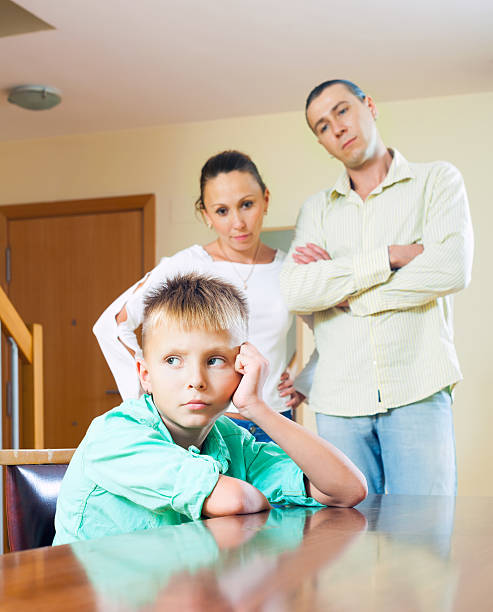 Parents scolding teenage child in home Parents scolding teenage child in home interior. Focus on boy 10 11 years photos stock pictures, royalty-free photos & images