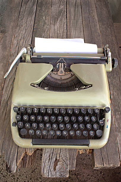 istock Old typewriter with blank paper on wooden background 486547866