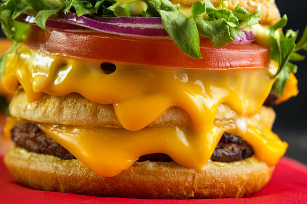 Melting cheese in burger Lot of melting cheese in burger closeup cheddar cheese stock pictures, royalty-free photos & images