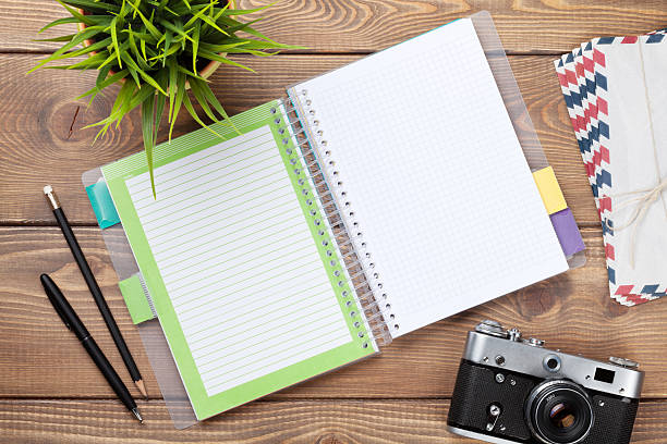 istock Office desk with calendar notepad, camera, supplies and flower 486549686