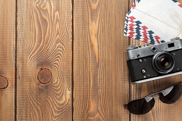 istock Camera, letters and sunglasses on office desk 486550330