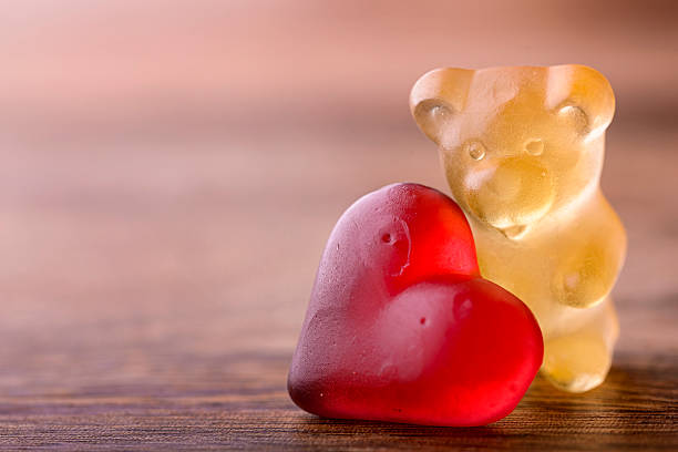 valentines bear gummy bear with red heart on wood for valentines gummi bears photos stock pictures, royalty-free photos & images