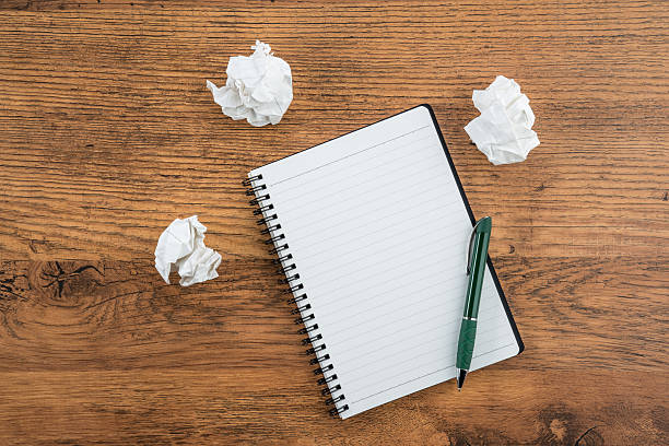 istock crumple paper and pen with notebook on the desk 486550976