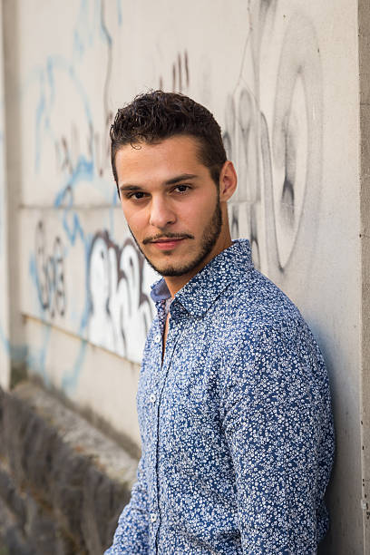 istock Young handsome man posing in the city streets 486552212