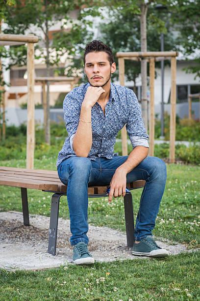istock Young handsome man posing in a city park 486552842